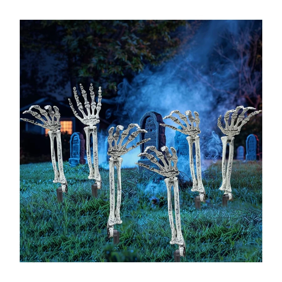 Six bone-white skeleton arms staked into a lawn