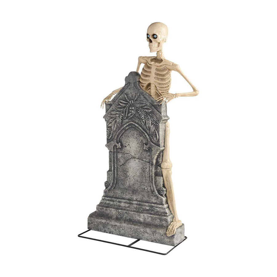A five foot headstone with a skeleton figure emerging from it