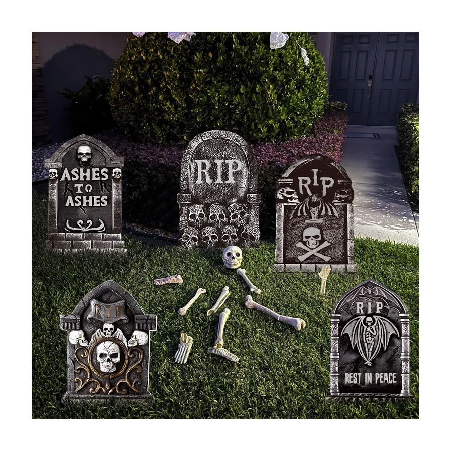 A set of grey moulded headstones staked in a lawn
