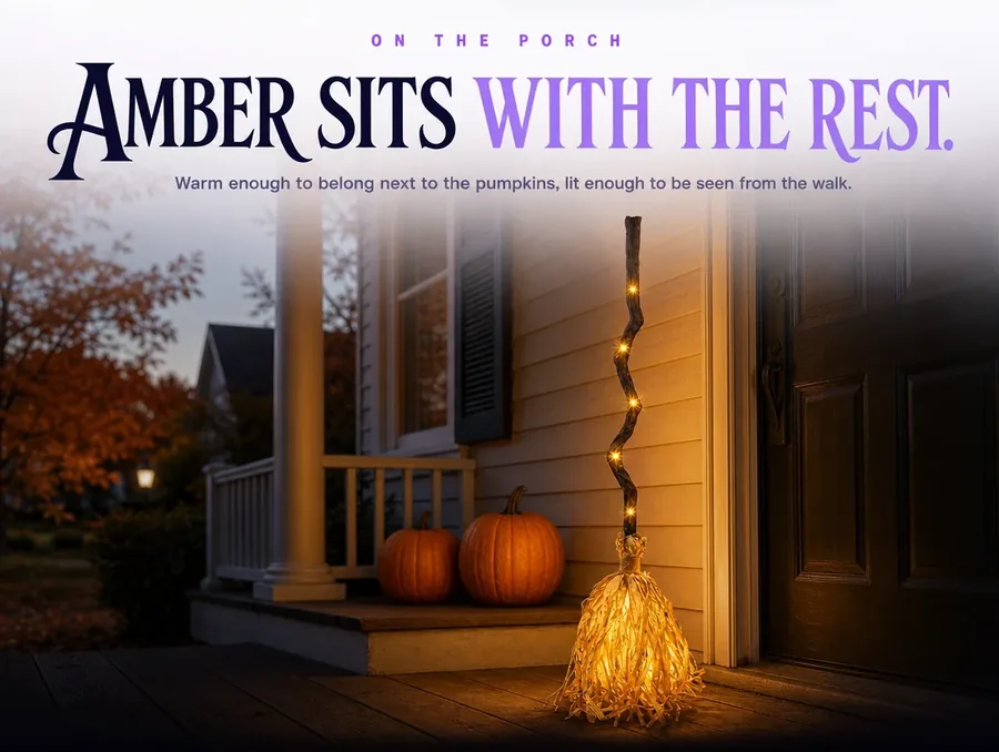 Lit warm amber on a covered porch at night, two plain pumpkins on the step behind