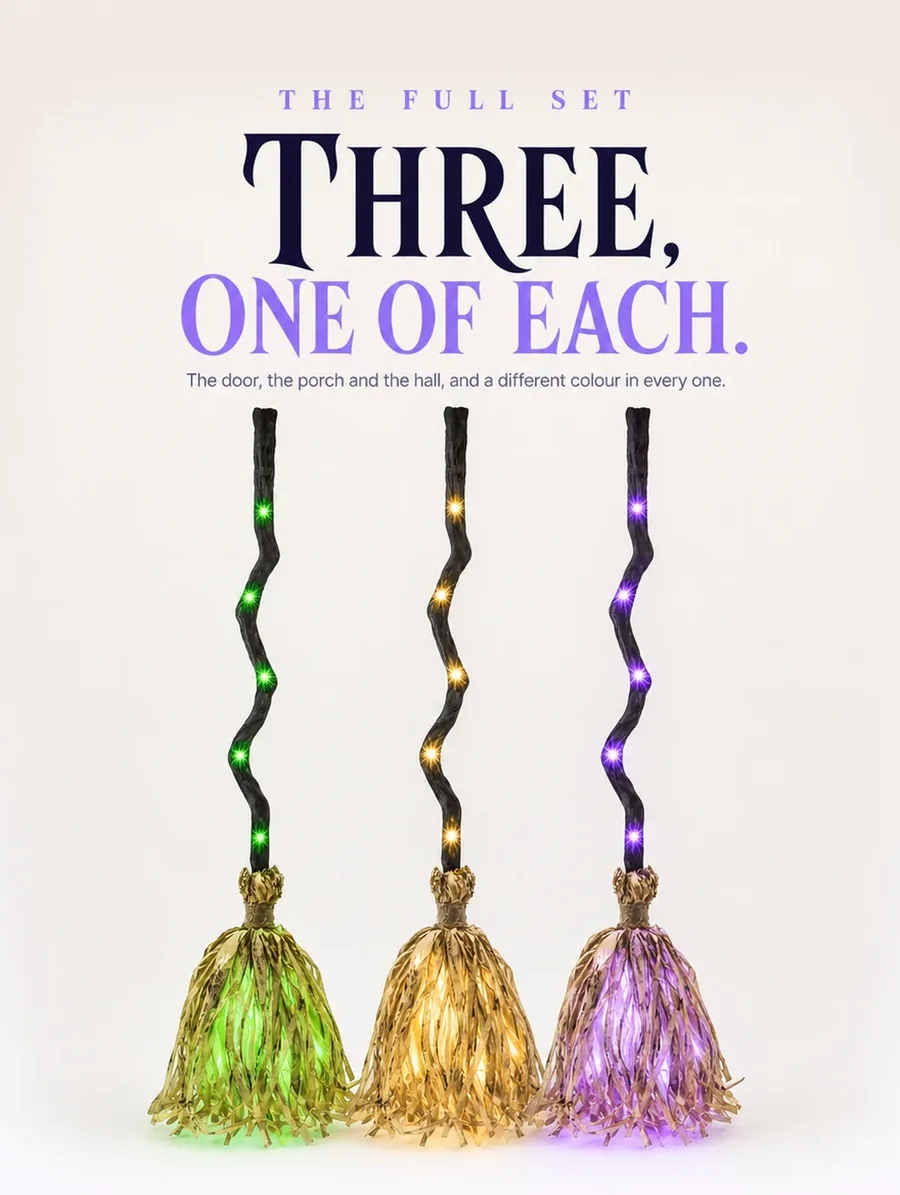 Three brooms in a row on pale studio paper, lit green, amber and violet