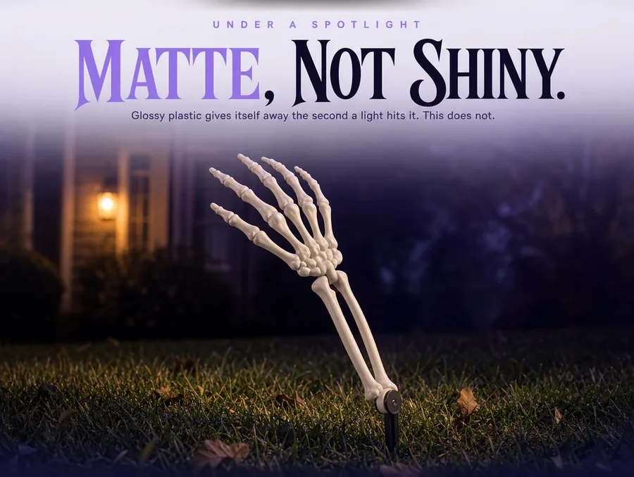 Extreme close view of the matte bone surface of a forearm under raking light.